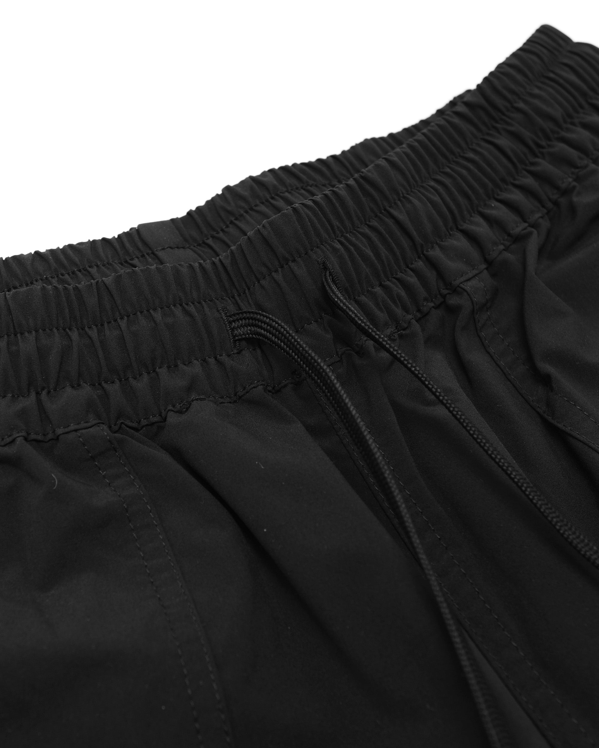 Close-up of black shorts with an elastic waistband on a white background