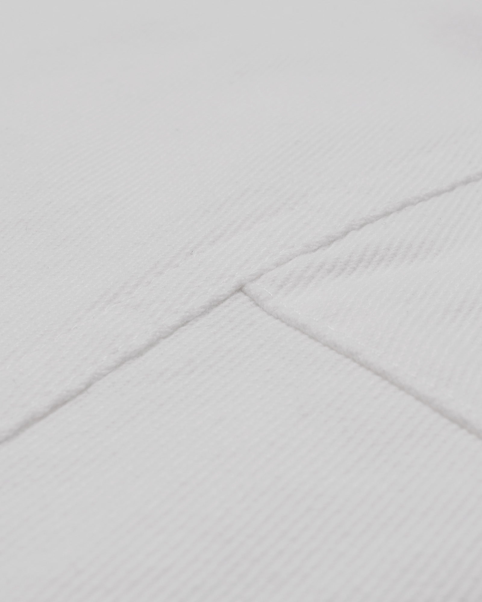 Close-up of a textured gray fabric with a diamond pattern