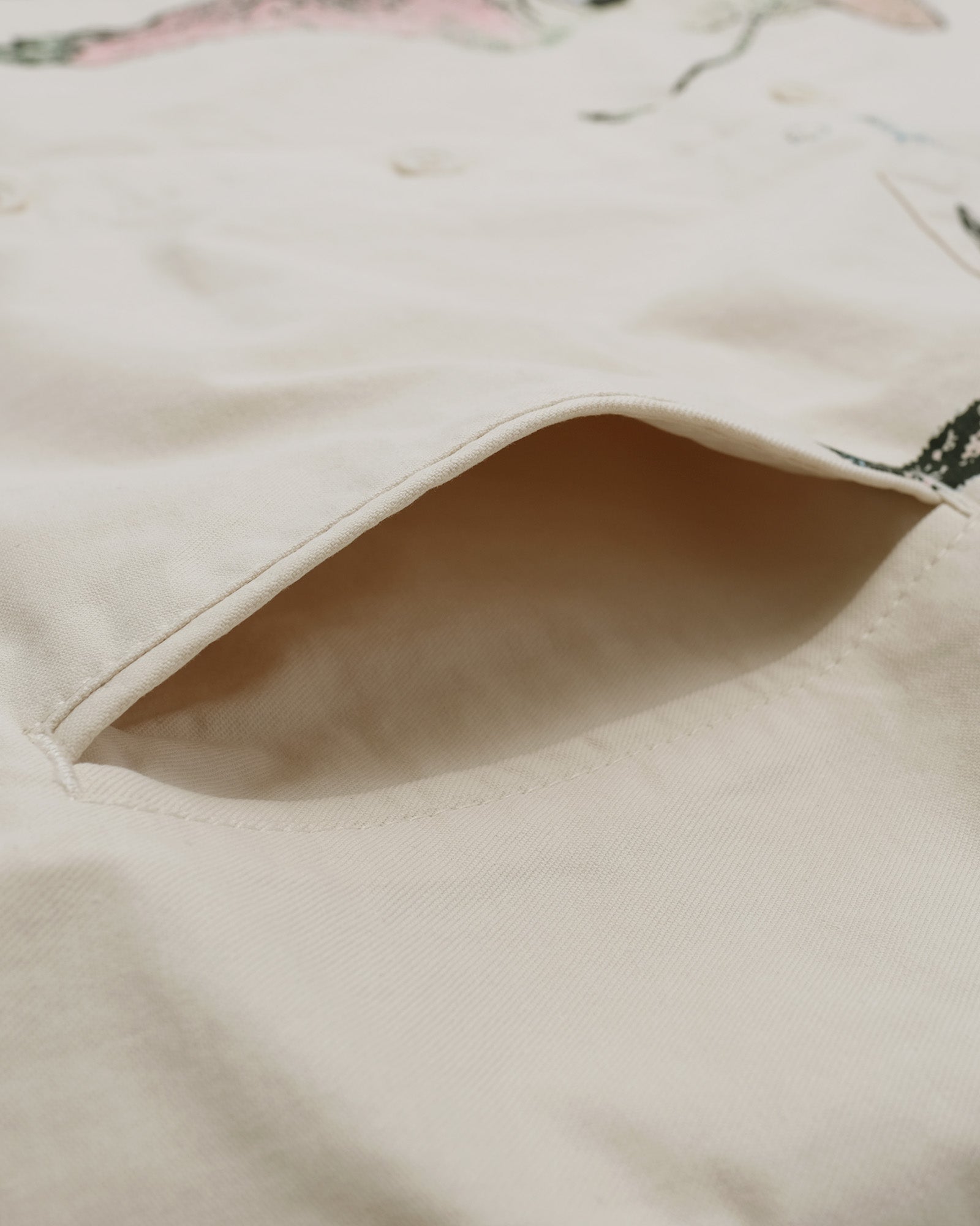 Close-up of beige fabric with floral pattern in the background