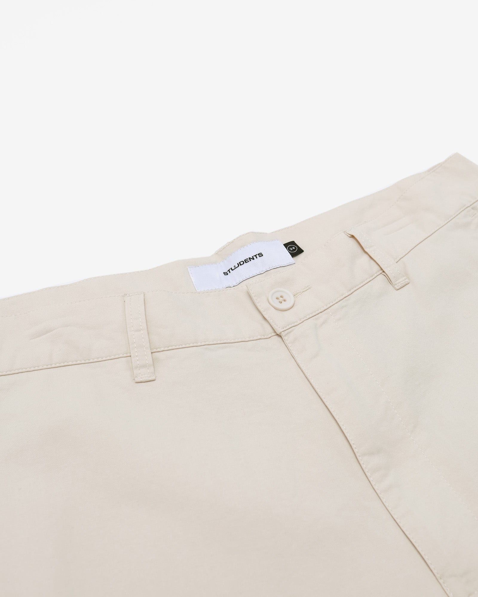 Beige pants with a brand label on a white background