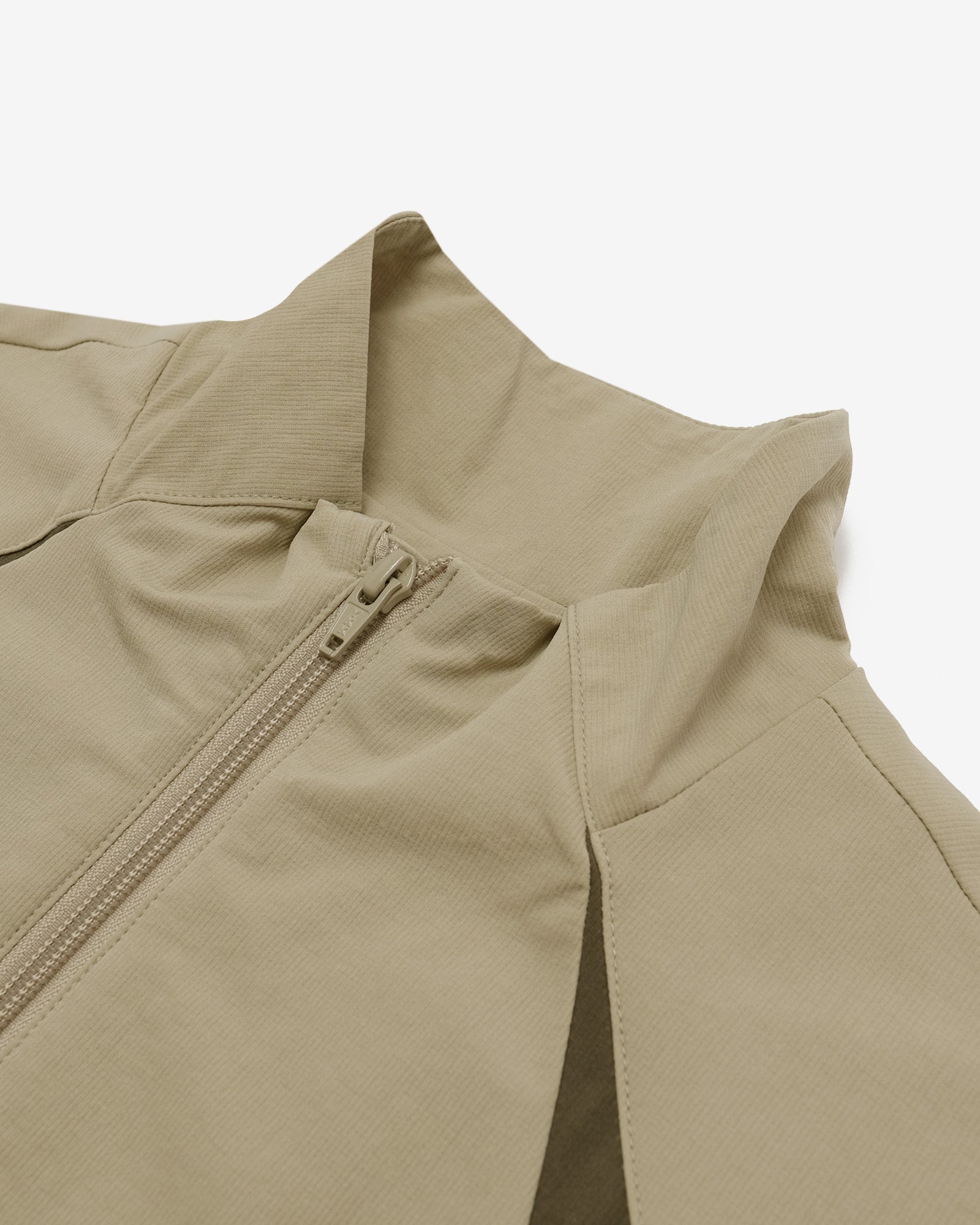 Beige jacket with a zipper on a light gray background