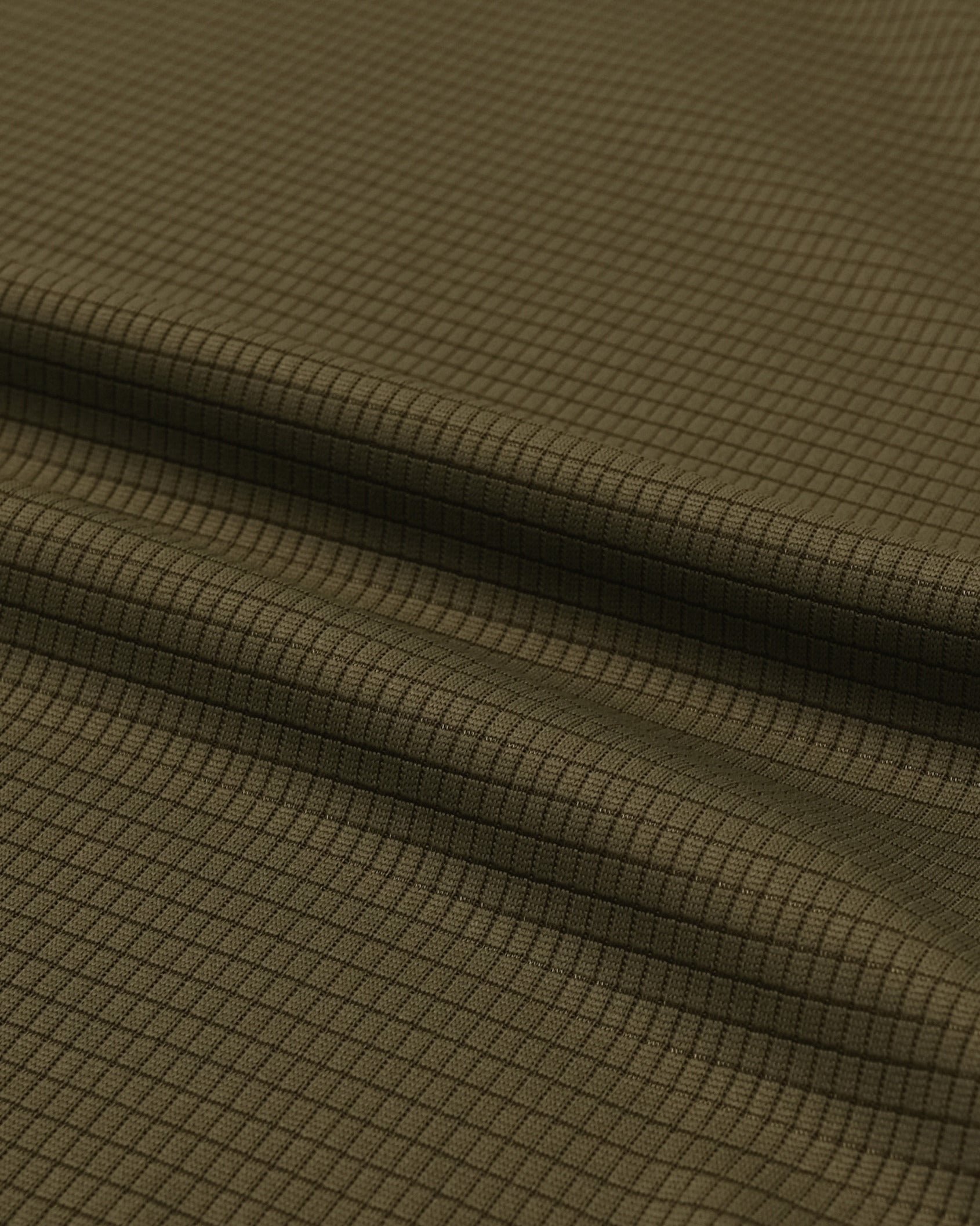 Close-up of olive green fabric with a subtle pattern