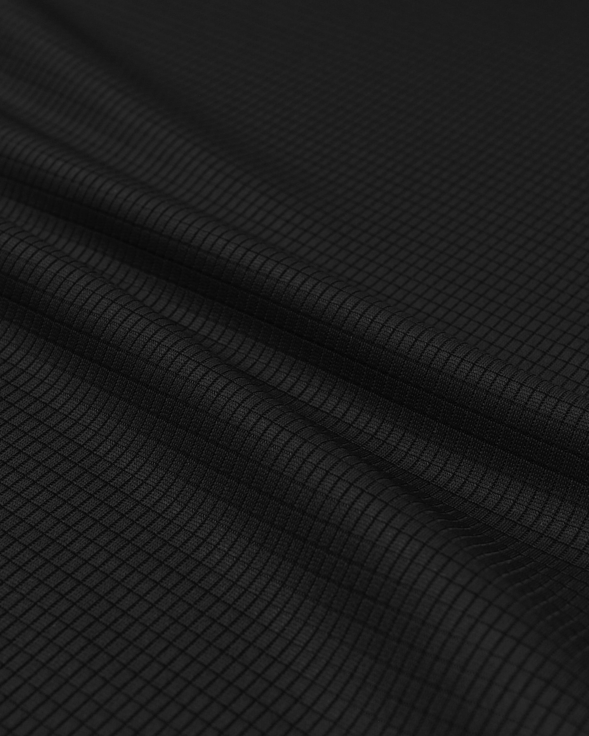 Close-up of black fabric with a subtle pattern