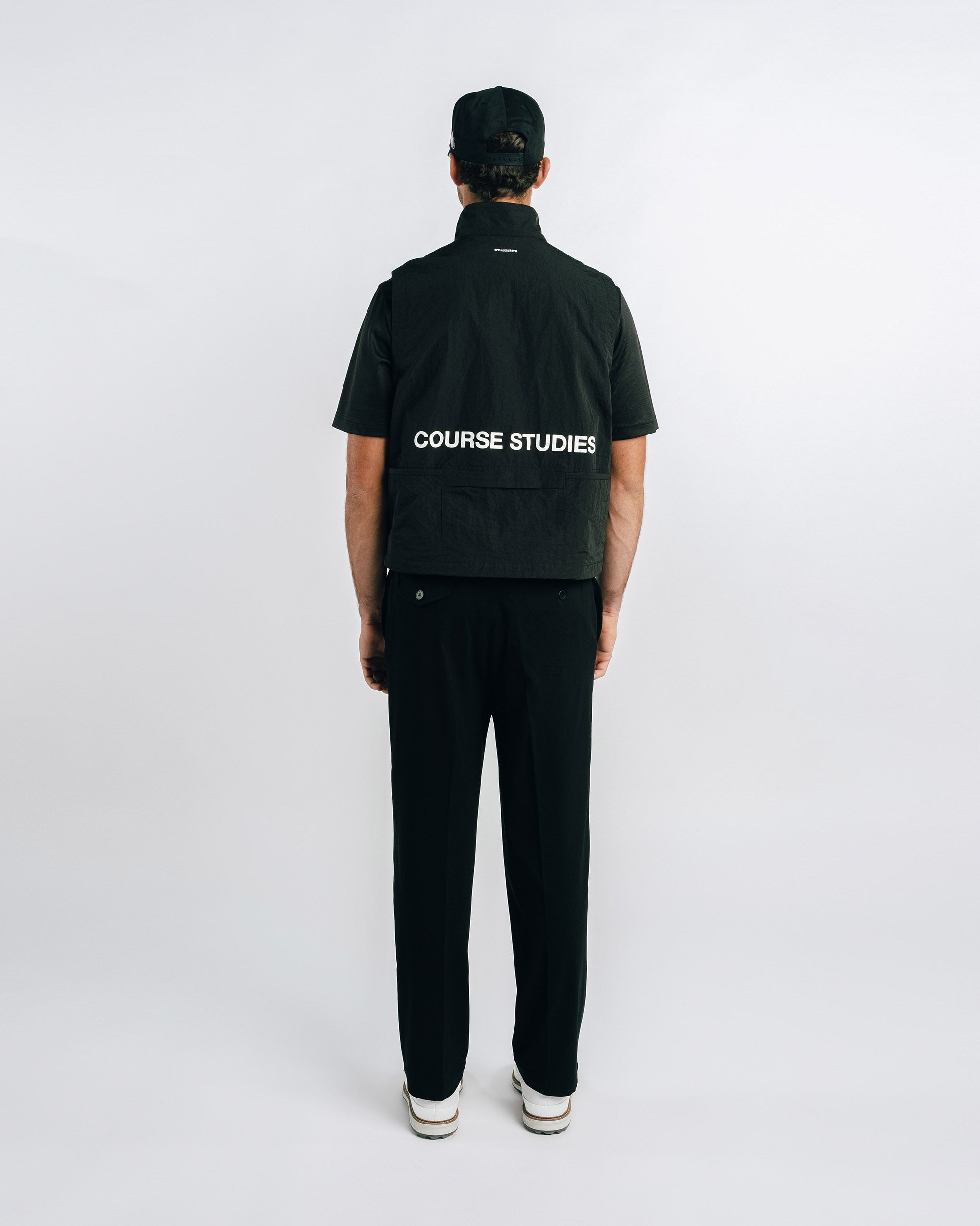 Person wearing a black jacket with 'Course Studies' branding on a white background