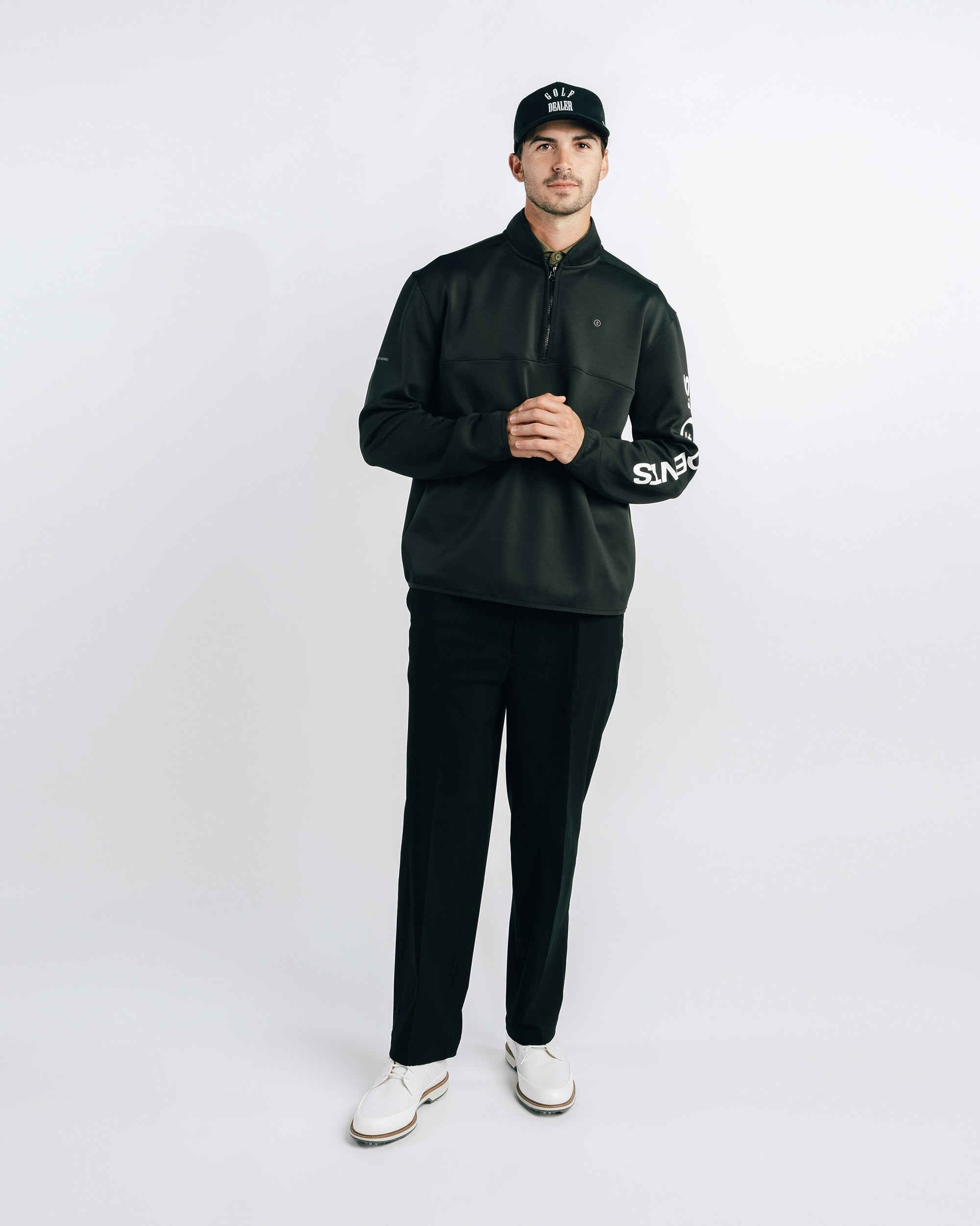 Man wearing a black outfit with 'Supreme' branding on a white background