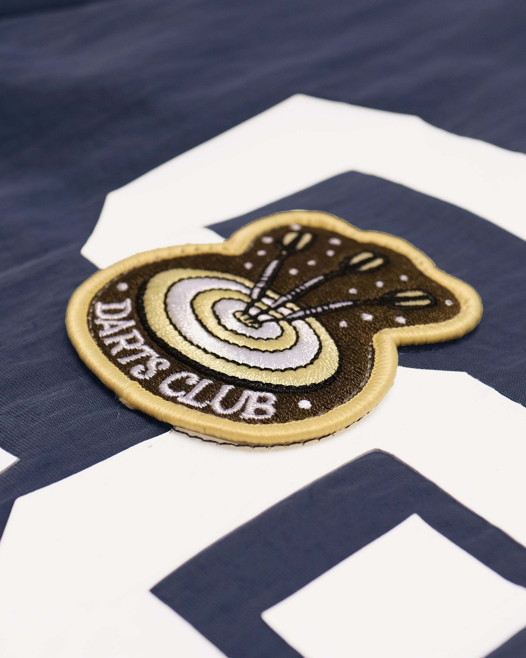 Patch with 'Darts Club' text on a sports jersey