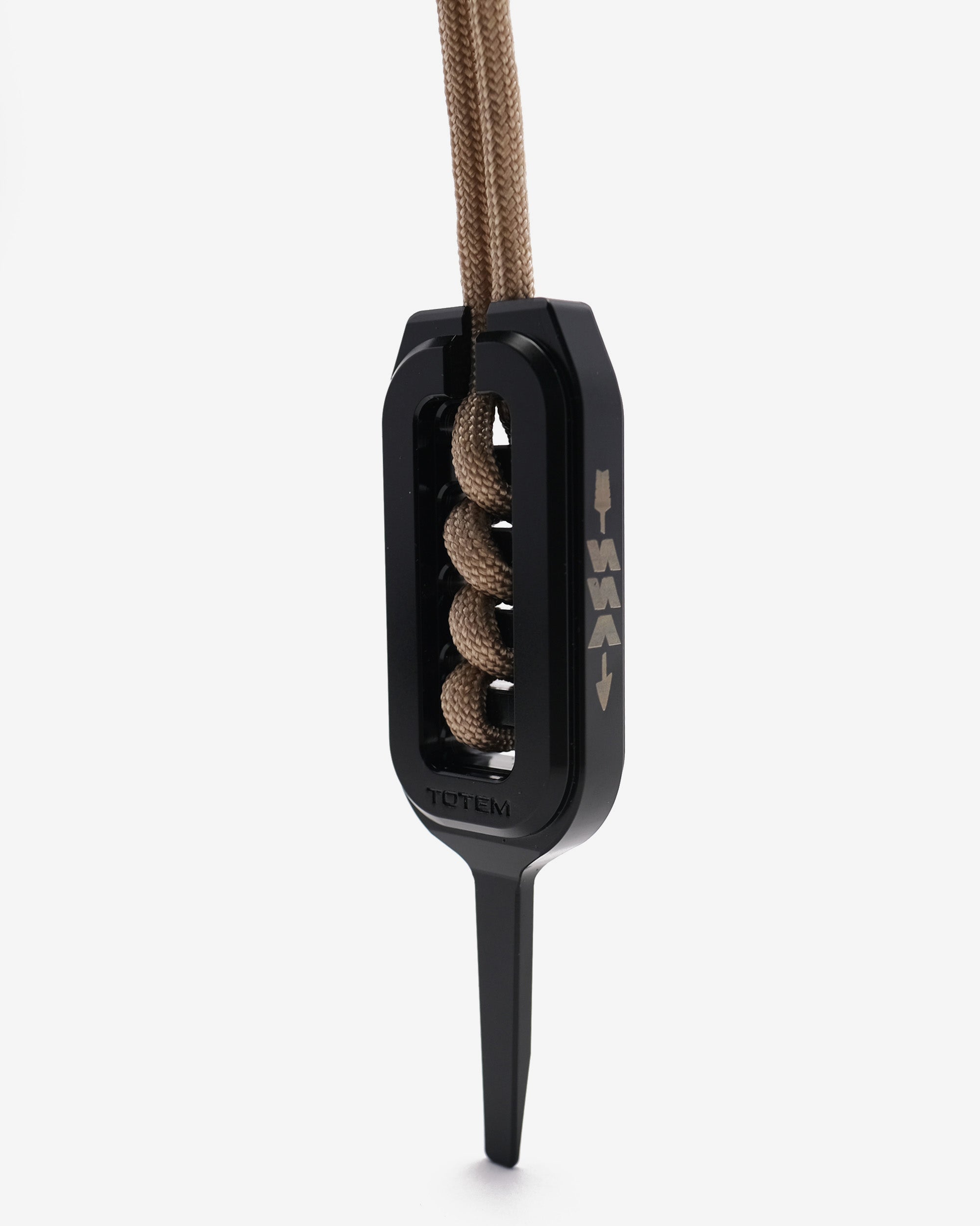 Black divot with brown string on a white background