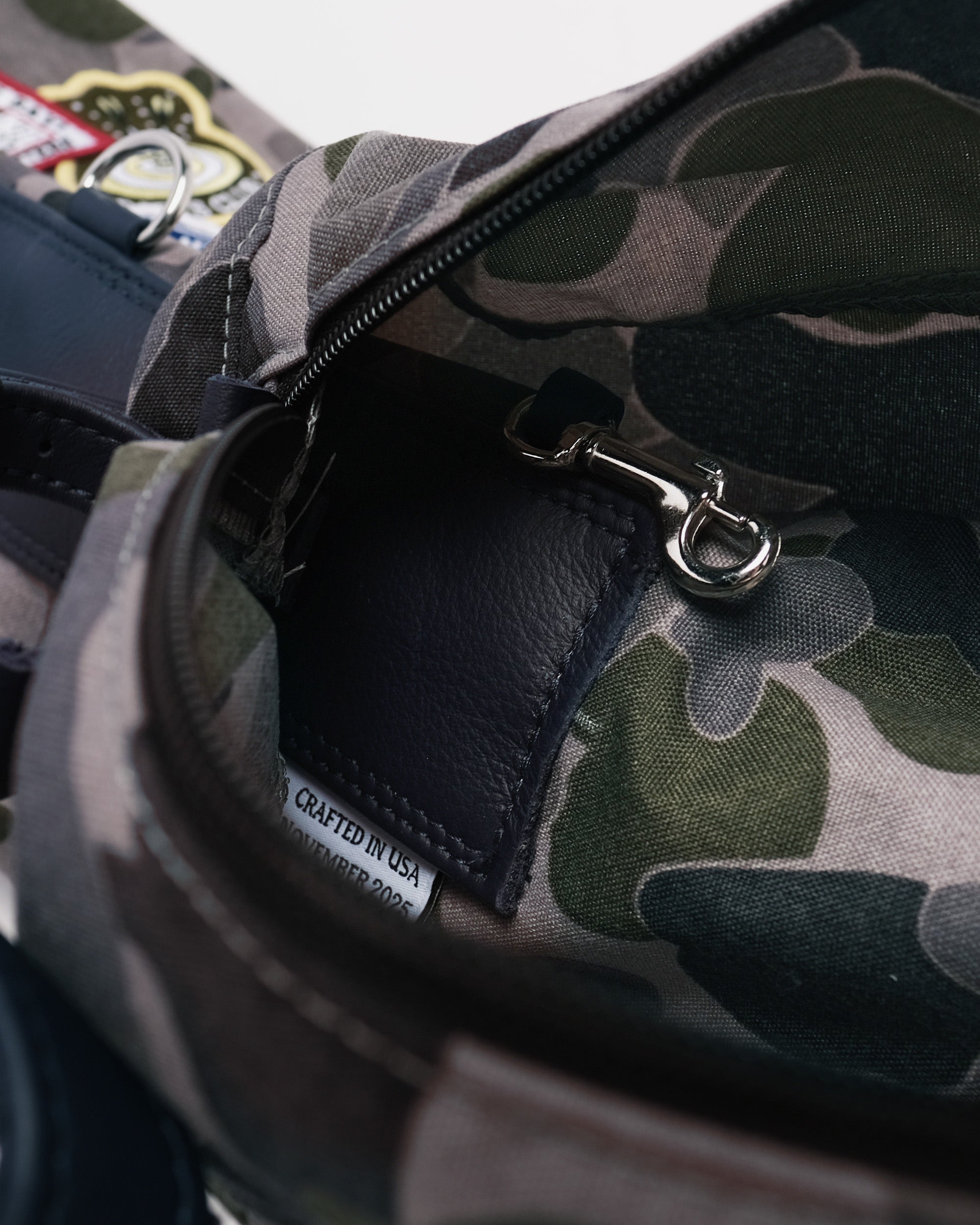 Camouflage bag with a visible 'Crafted in USA' label on a blurred background