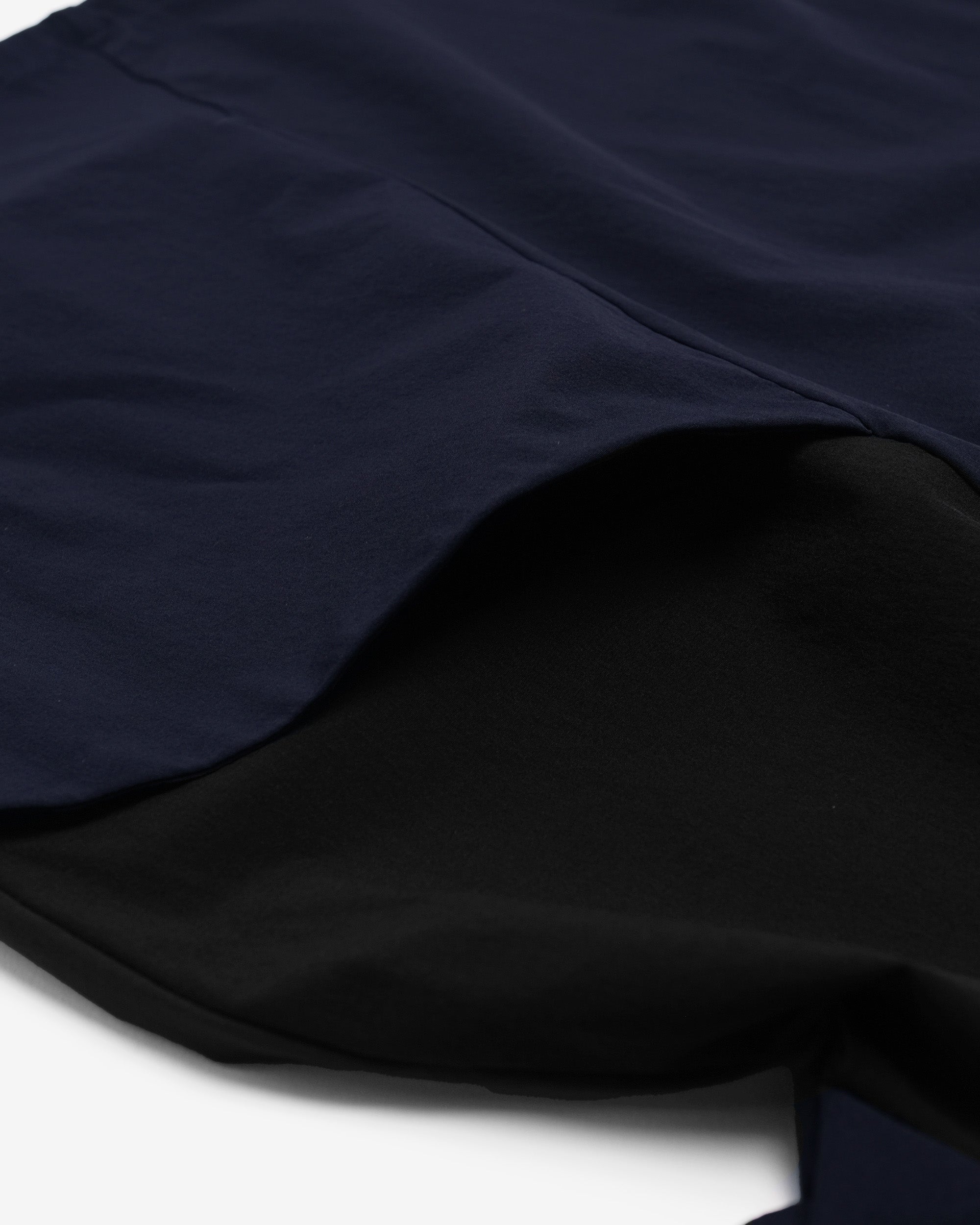 Close-up of dark blue fabric with a white background