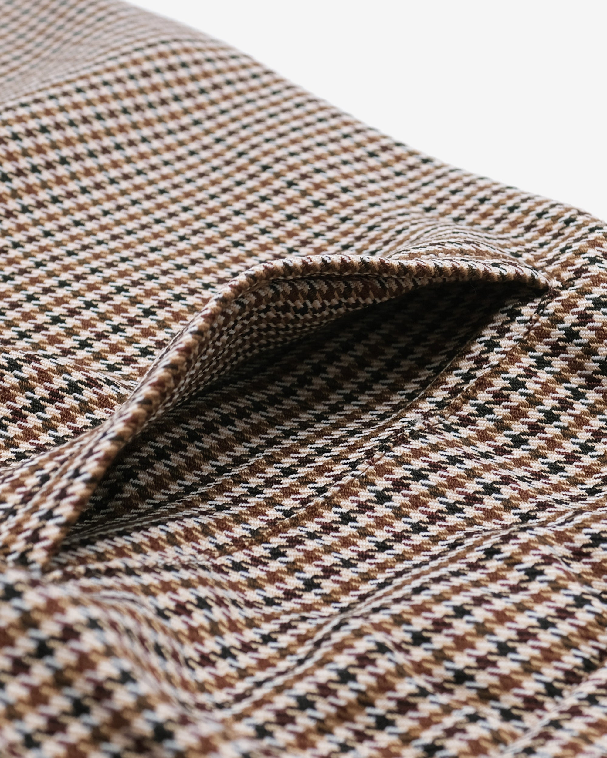 Close-up of a patterned fabric with brown, black, and beige colors.