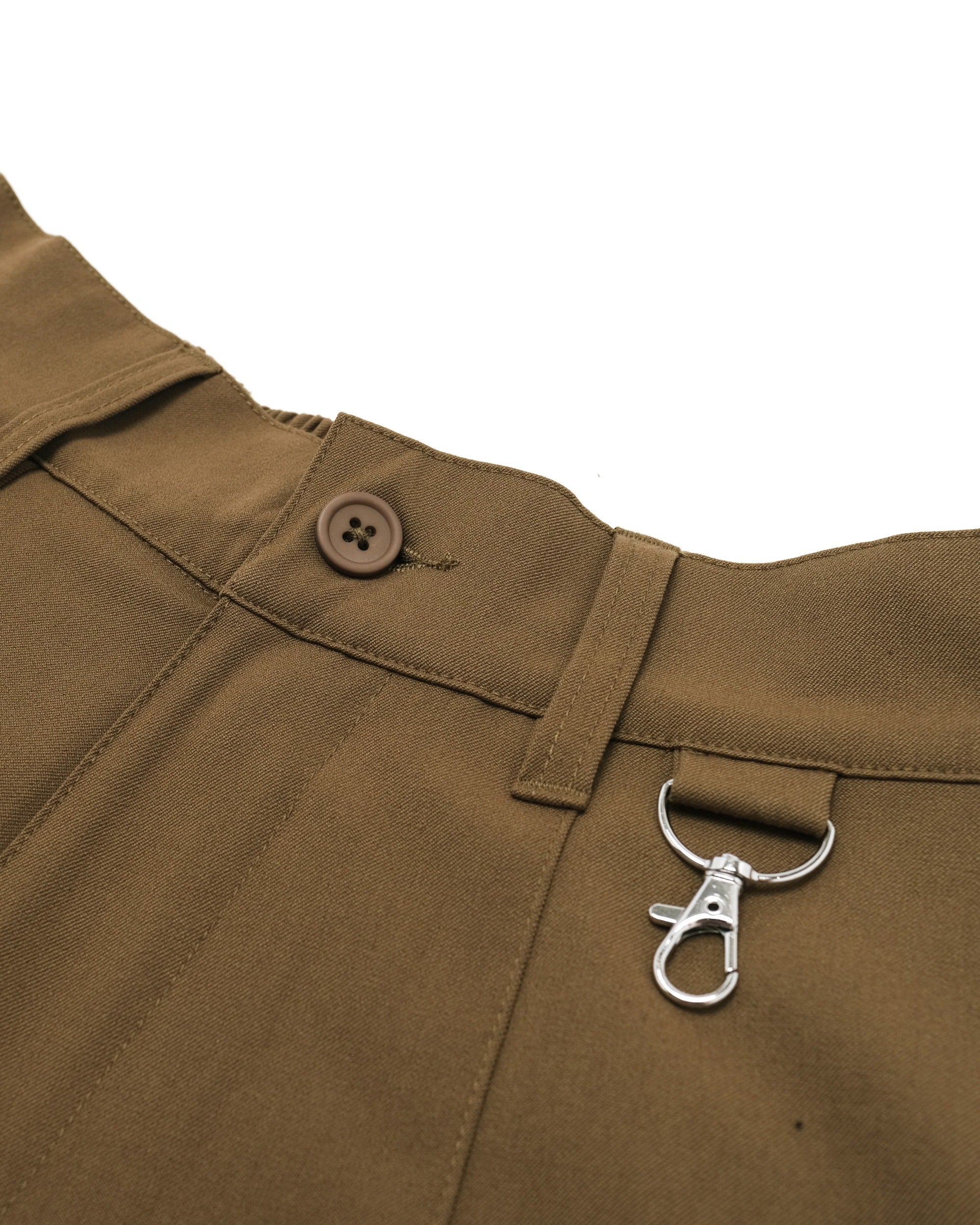 Brown fabric with a button and metal clasp on a white background