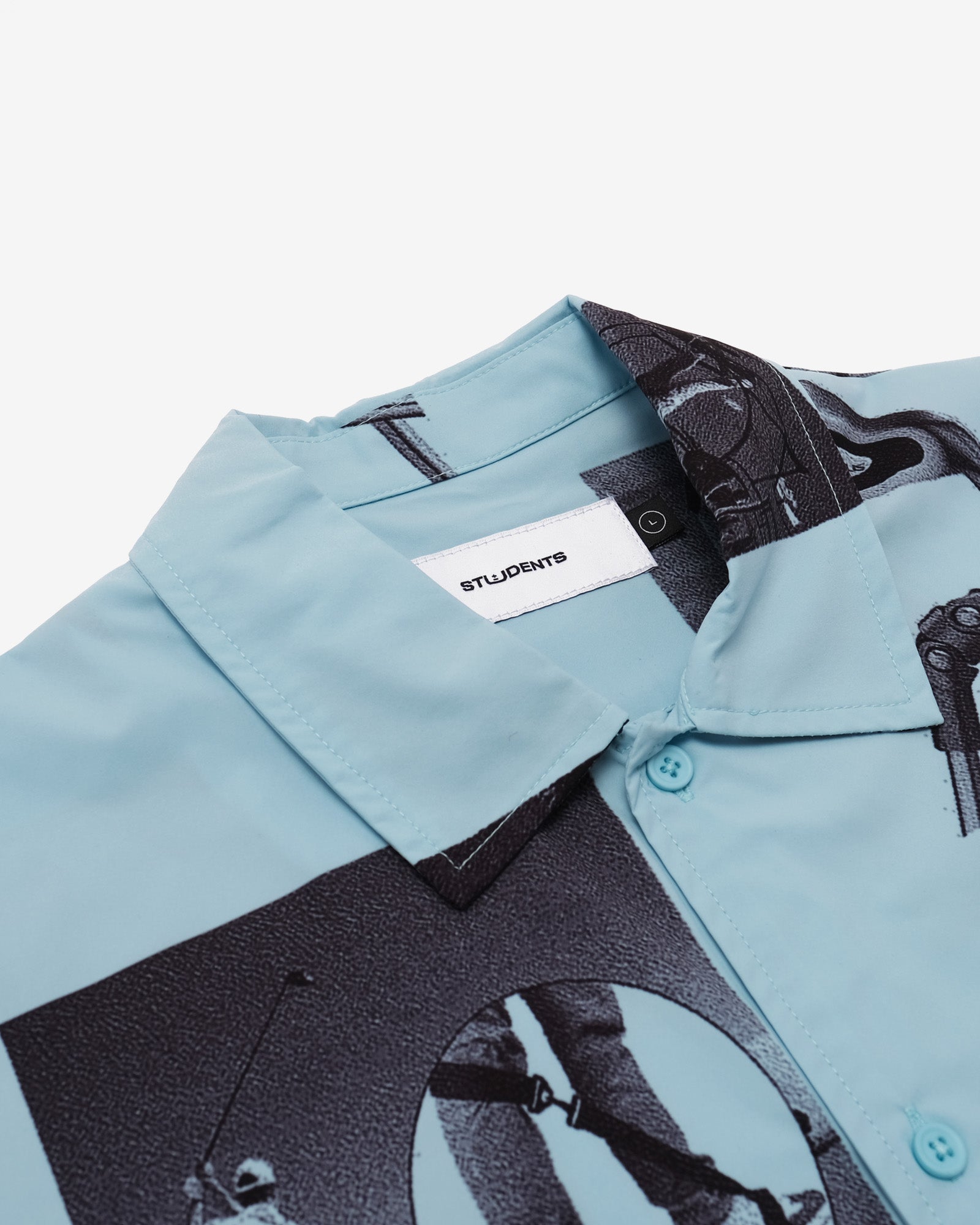 Light blue shirt with black graphic design and 'STUDENTS' label on a white background