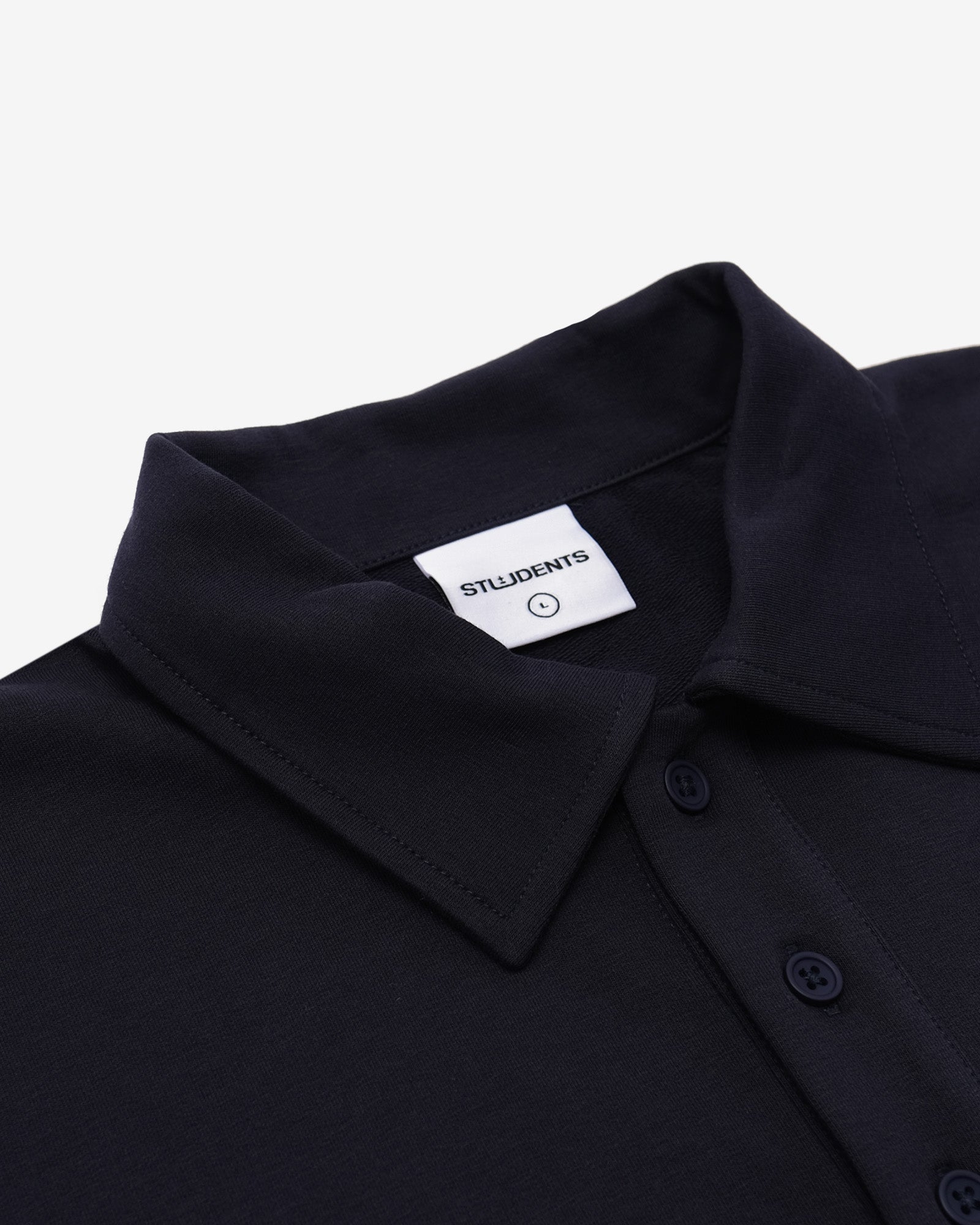 Black shirt collar with a visible brand label on a white background
