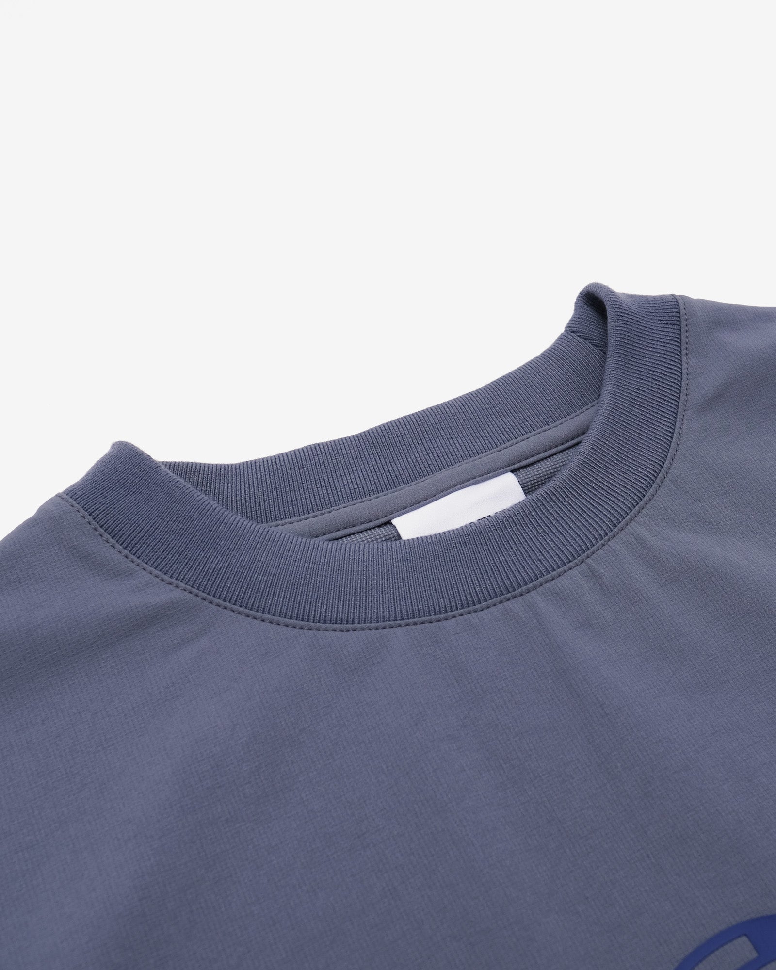 Close-up of a blue t-shirt collar on a white background
