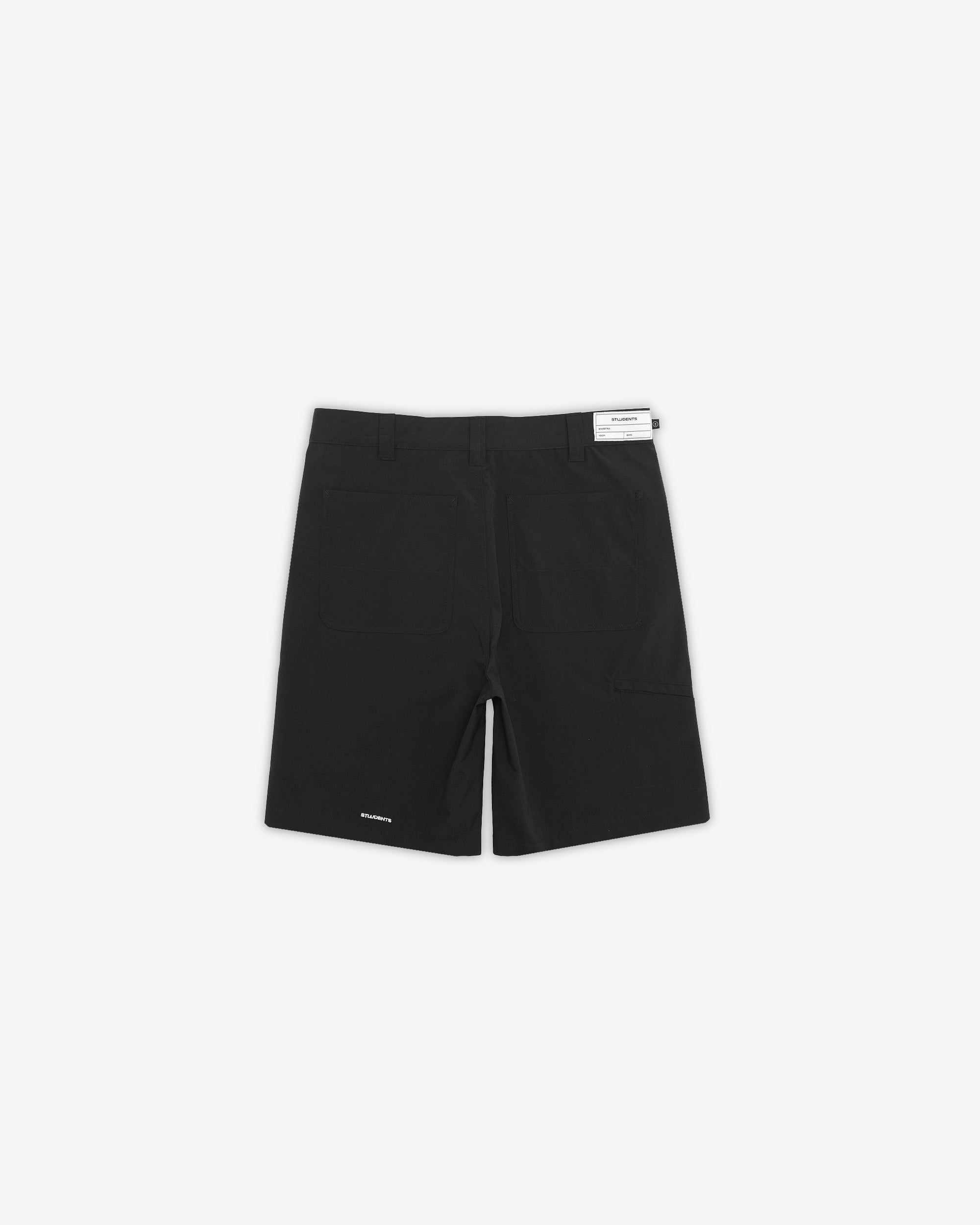 Black shorts with a brand label on a white background
