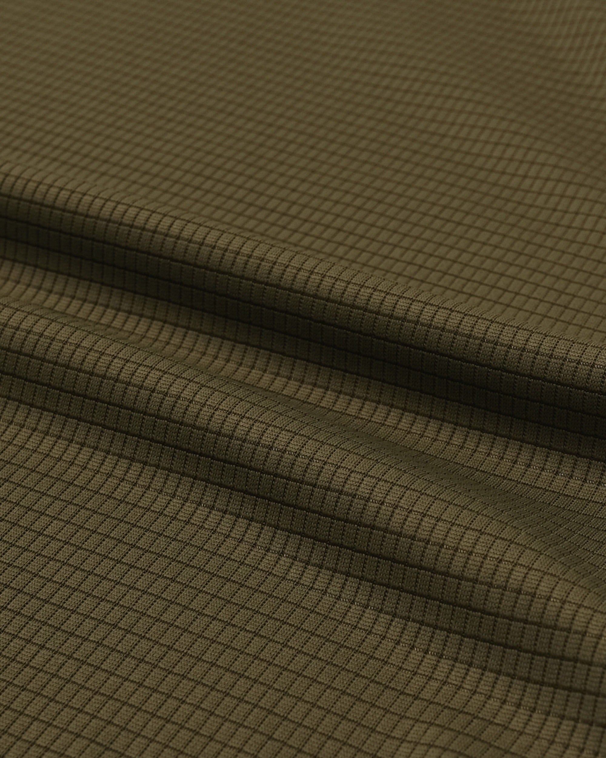 Close-up of olive green fabric with a subtle pattern