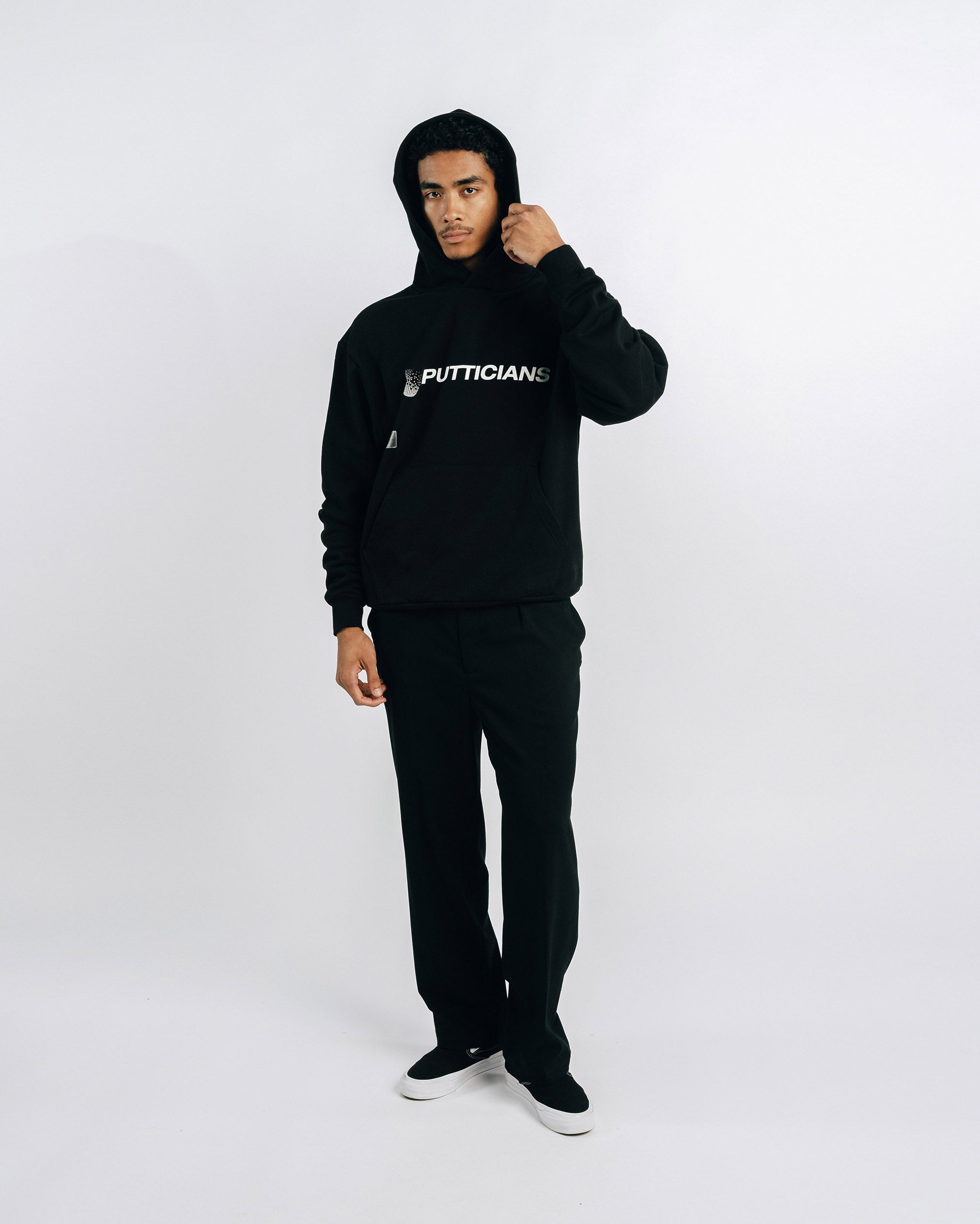 Person wearing a black hoodie with text on a white background