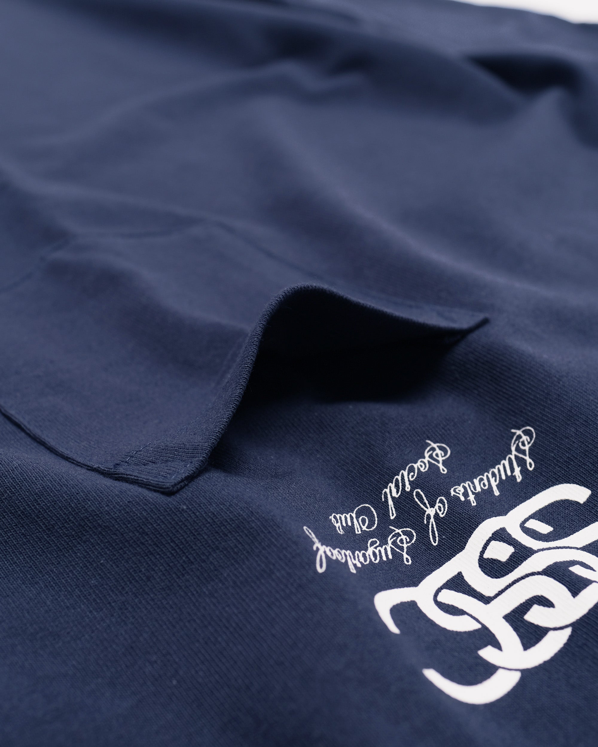 Navy blue fabric with white embroidery on a white background