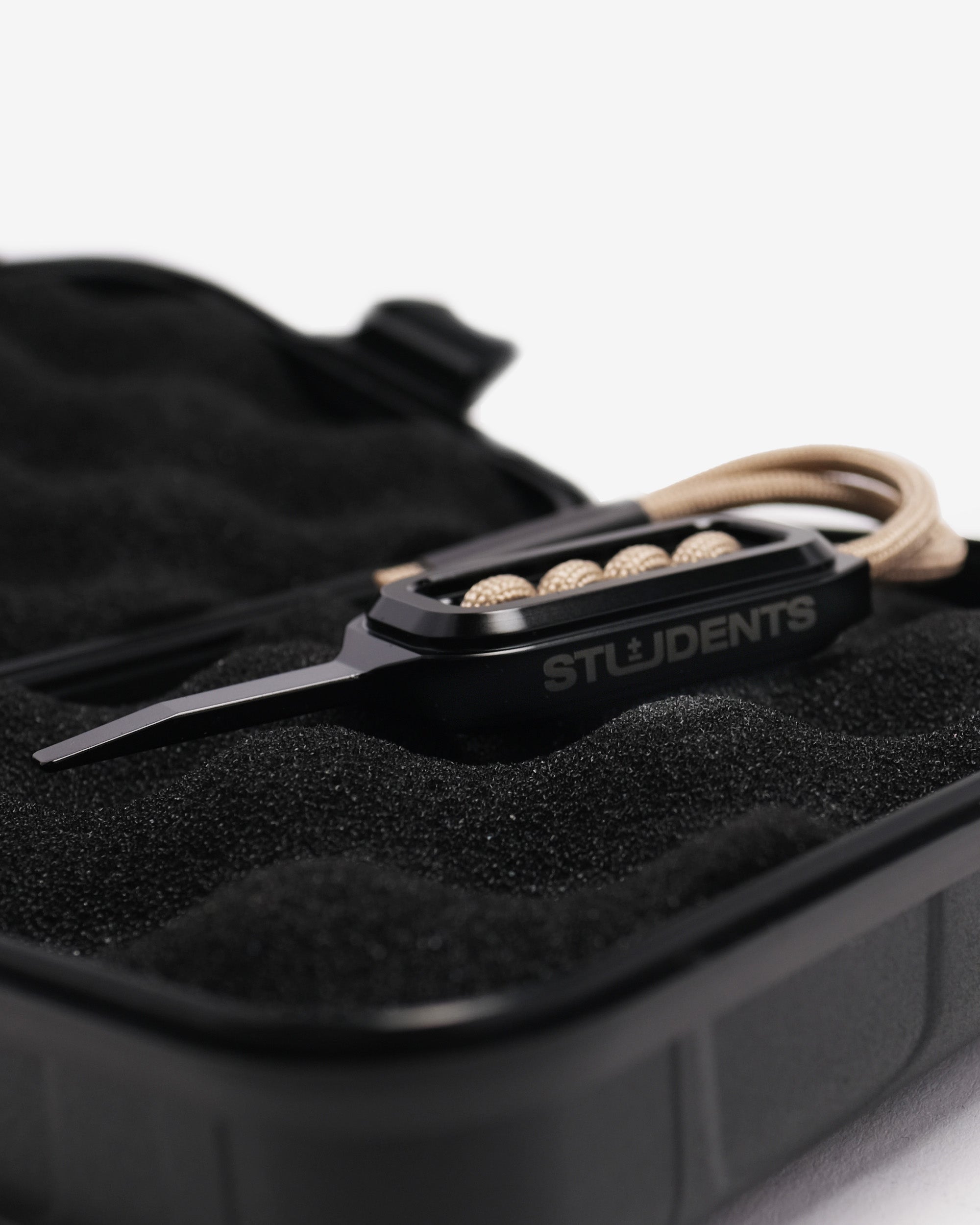 Black divot with 'STUDENTS' branding on a black case.
