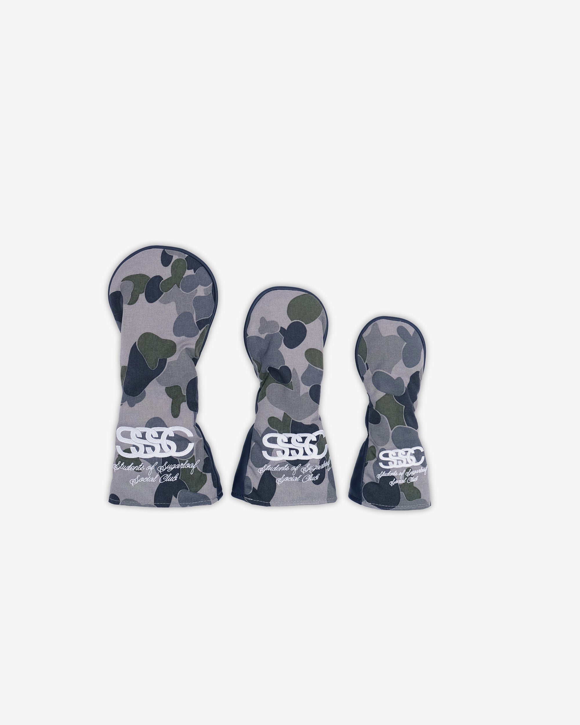 Three golf club head covers with camouflage pattern on a white background
