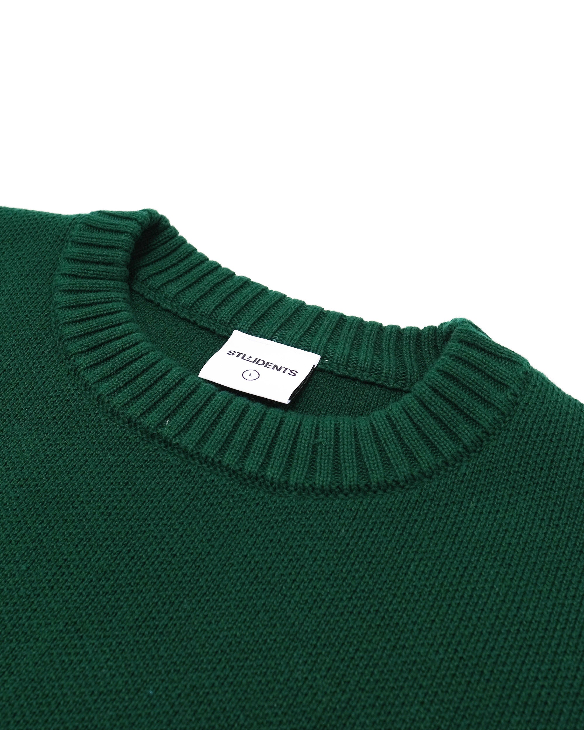 Green sweater with a brand label on a white background