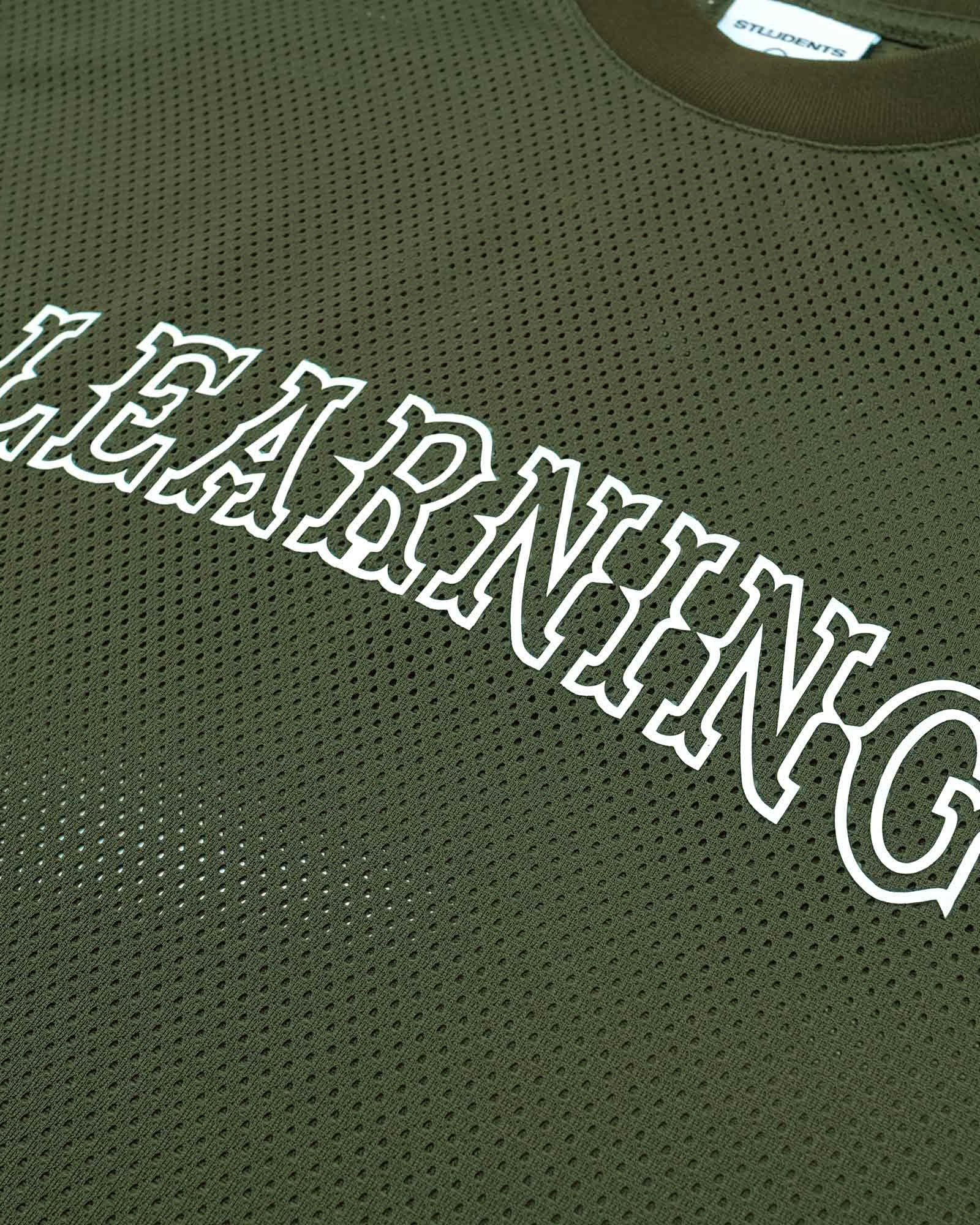 Green mesh shirt with 'LEARNING' text on a plain background