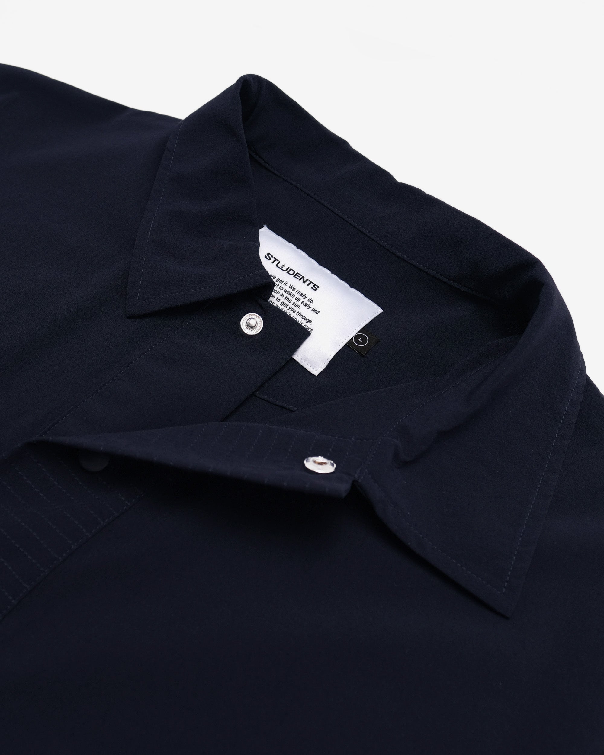 Navy blue shirt collar with a brand label on a white background