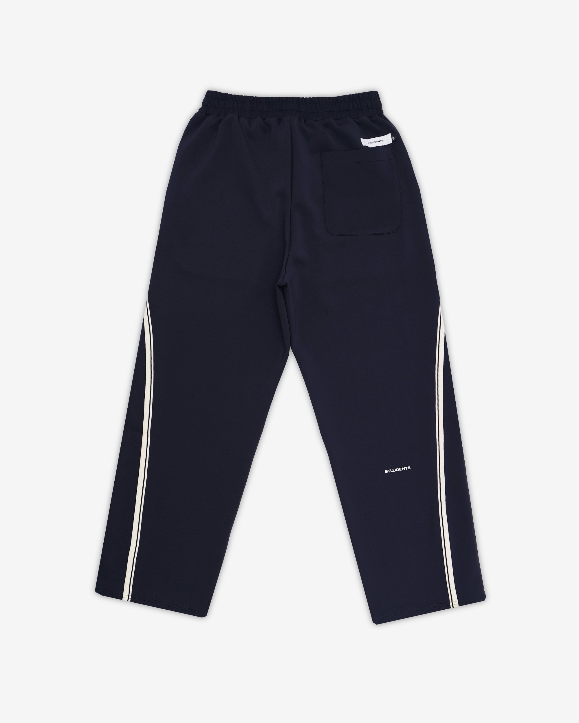 Navy track pants with white stripes on a white background