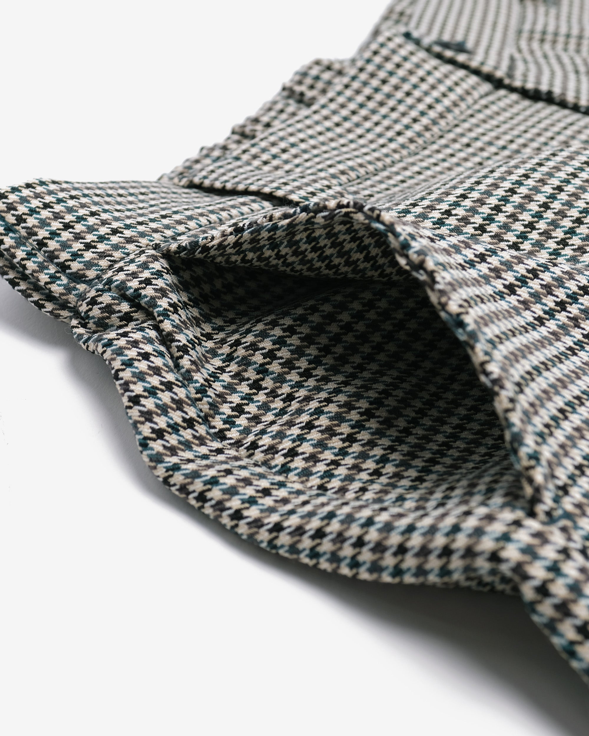 Close-up of a textured fabric with a checkered pattern on a white background
