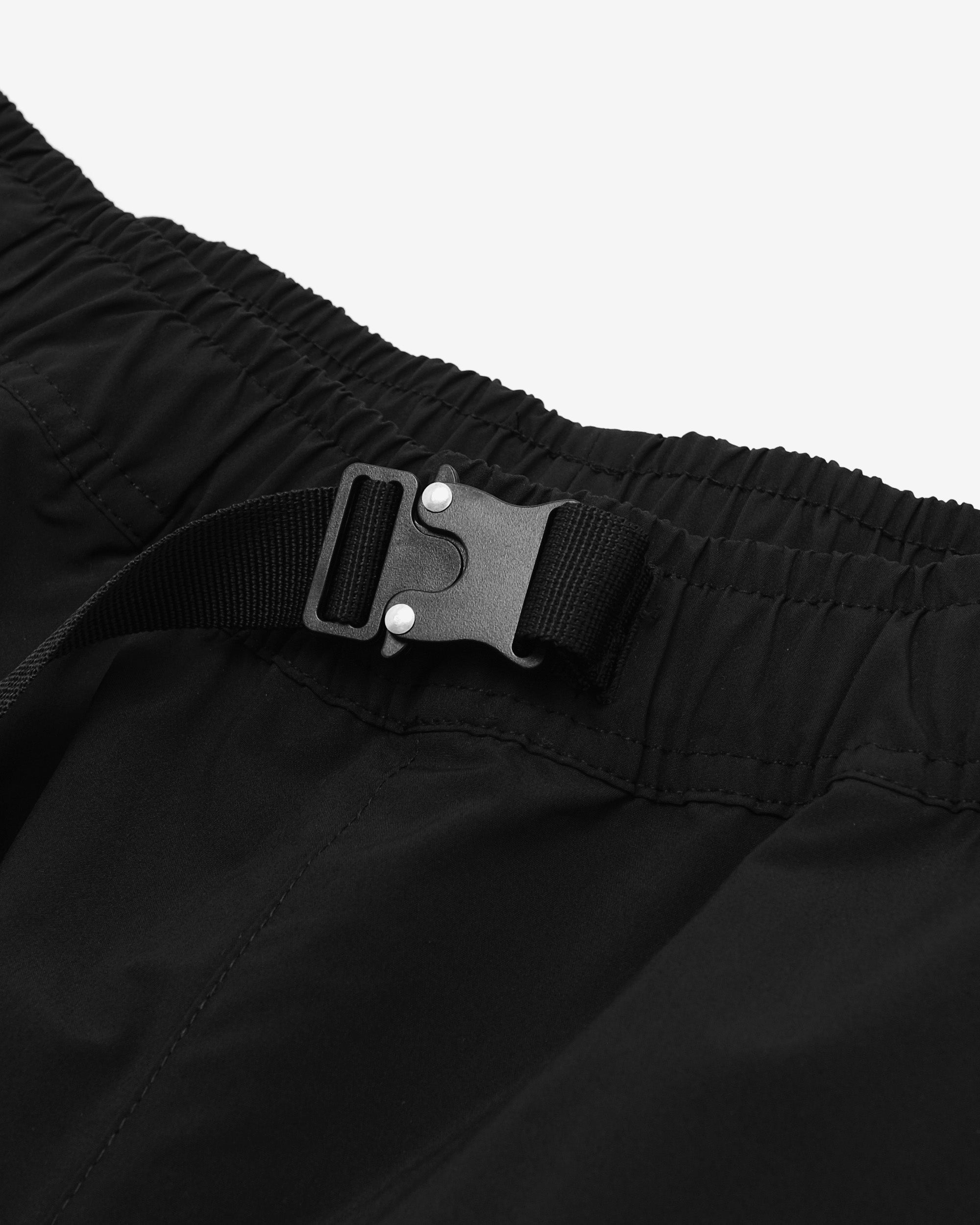 Close-up of black pants with a buckle on a light gray background